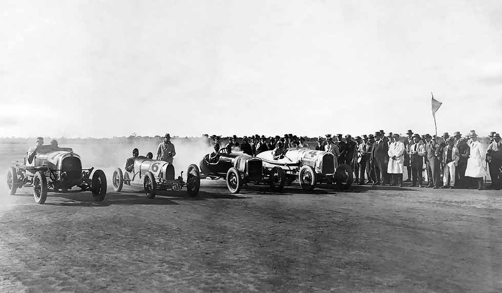1925 50-mile championship race with Colliver’s Chrysler, Poole’s Bugatti, Cranston’s Ford and Smith’s Buick; Ron West in his Brax Dodge at the 2014 Centenary; Wizard Smith’s team; motorcycle ace Sprouts Elder drifts in style, 1928. 
