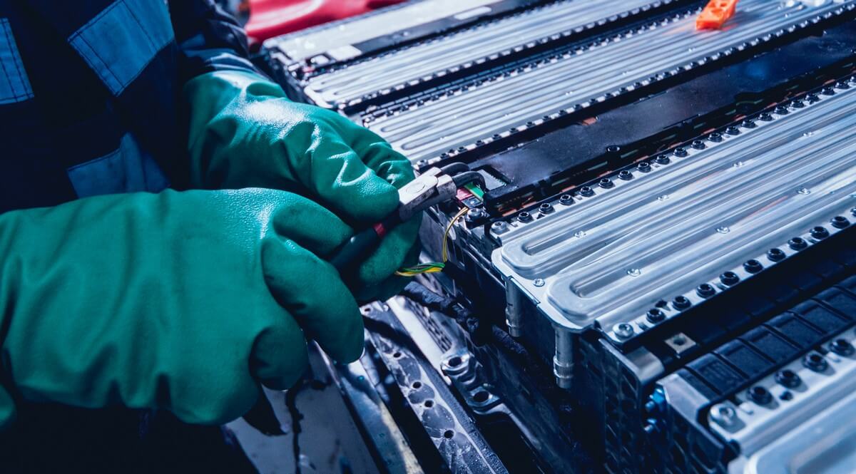 Mechanic disassembling electric car battery